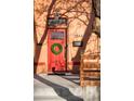 Close-up of the red front door with wreath, classic hardware, and brick facade at 2844 N Humboldt St, Denver, CO 80205