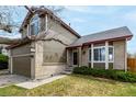 Charming two-story home with a two-car garage, brick accents, and manicured landscaping at 4165 S Granby Cir, Aurora, CO 80014