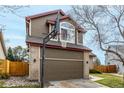 Two-story home with a two-car garage, basketball hoop, brick accents, and landscaping at 4165 S Granby Cir, Aurora, CO 80014