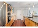 Contemporary kitchen featuring stainless steel appliances, tile backsplash, and ample counter space at 1620 Little Raven St # 302, Denver, CO 80202