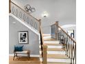 Elegant staircase featuring decorative metal railings and hardwood treads at 6002 Alkire Ct, Arvada, CO 80004