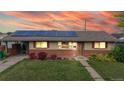 Charming single-story home featuring solar panels, well-maintained lawn, and inviting curb appeal at 41 S Fenton St, Lakewood, CO 80226