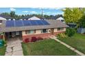 Elevated view of a single-story home featuring solar panels, well-maintained lawn, and charming curb appeal at 41 S Fenton St, Lakewood, CO 80226
