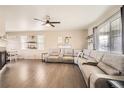 Spacious living room featuring a large sectional, hardwood floors, and a decorative fireplace at 5177 Delphinium Cir, Brighton, CO 80601