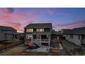 Backyard with hot tub, deck, and basketball court, at dusk at 1210 Horsetail Loop, Elizabeth, CO 80107