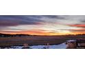 Scenic sunset view over fields and mountains at 1210 Horsetail Loop, Elizabeth, CO 80107