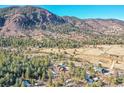 Aerial view of the mountain community, showcasing the home's location, its wooded surroundings, and mountain view at 778 Suncrest Rd, Palmer Lake, CO 80133