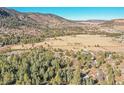 An aerial shot of the property revealing a panoramic view of the surrounding landscape, including mountains and open fields at 778 Suncrest Rd, Palmer Lake, CO 80133