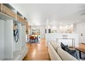 Bright, open-concept living space with hardwood floors, built-in storage, and seamless flow into the dining area at 3560 S Glencoe St, Denver, CO 80237
