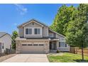 Charming two-story home with a well-maintained lawn and a two car garage at 6230 Snowberry Ave, Firestone, CO 80504