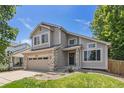 Charming two-story home with a well-maintained lawn and a two car garage at 6230 Snowberry Ave, Firestone, CO 80504