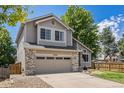 Charming two-story home with a well-maintained lawn and a two car garage at 6230 Snowberry Ave, Firestone, CO 80504