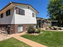 This home features a lush lawn and attractive landscaping. Also a brick and siding exterior at 1299 S Brentwood Way, Lakewood, CO 80232