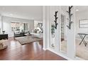 Bright and airy living room with hardwood floors, large windows, and modern furniture at 18180 W 84Th Pl, Arvada, CO 80007
