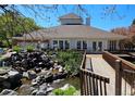 Clubhouse with a charming water feature and wooden walkway at 13762 E Lehigh Ave # G, Aurora, CO 80014