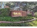 A landscaped brick entrance to Meadow Hills with green bushes and a brick walkway at 13762 E Lehigh Ave # G, Aurora, CO 80014
