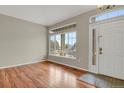 Inviting entryway with gleaming hardwood floors and plenty of natural light from large windows at 21684 Swale Ave, Parker, CO 80138