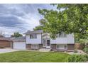Charming split-level home featuring a well-manicured lawn and brick accents on the facade at 845 S 9Th Ave, Brighton, CO 80601