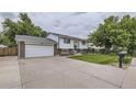 Split-level home with a driveway and well-manicured lawn at 845 S 9Th Ave, Brighton, CO 80601