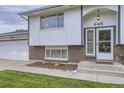 Close up of the split-level home's front porch with a brick facade at 845 S 9Th Ave, Brighton, CO 80601