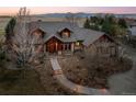 A gorgeous home featuring professional landscaping, a stone driveway, and exterior architecture at 8912 Little Raven Trl, Niwot, CO 80503