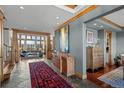 Bright foyer with wood trim, tiled floors, views of the living room, and decorative furnishings at 8912 Little Raven Trl, Niwot, CO 80503