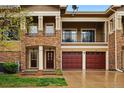 Charming townhome with stone facade, balcony, and driveways to attached garages at 6212 Kilmer Loop # 202, Golden, CO 80403