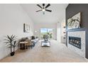 Bright living room with fireplace, balcony access, and vaulted ceiling at 6212 Kilmer Loop # 202, Golden, CO 80403