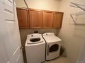 Practical laundry room equipped with a washer, dryer, and overhead cabinets for ample storage at 10129 Grove Ct # B, Westminster, CO 80031