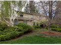 Two-story brick home featuring mature landscaping and a private, tree-lined yard at 4070 S Hudson Way, Englewood, CO 80113