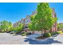 Row of townhomes featuring attached garages, brick accents, and well-maintained landscaping at 5426 Dtc Pkwy, Greenwood Village, CO 80111