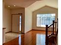Bright living room with hardwood floors, vaulted ceilings, and large windows offering ample natural light at 1022 Morning Dove Dr, Longmont, CO 80504