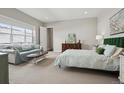 Spacious main bedroom featuring a cozy sitting area, ample natural light, and serene ambiance for relaxation at 5622 Shadescale Way, Castle Rock, CO 80104