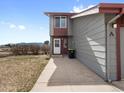 Side exterior view with vinyl siding, mountain views, and a well-maintained lawn at 760 Century Pl # A, Monument, CO 80132