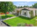 Inviting exterior view showcasing the home's lush lawn, quaint facade, and pleasant landscaping at 4389 S Sherman St, Englewood, CO 80113