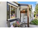 Cozy front porch with rocking chairs, flowers, and a 'welcome' sign, creating a warm and inviting ambiance at 4389 S Sherman St, Englewood, CO 80113