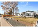 Attractive single-story house with a well-maintained yard and a welcoming front porch and a welcoming welcome sign at 4389 S Sherman St, Englewood, CO 80113