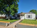 Cozy single-story home with a well-kept lawn and inviting front porch, perfect for enjoying the outdoors at 4389 S Sherman St, Englewood, CO 80113
