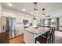 Modern kitchen with white cabinets, stainless steel appliances, granite countertops and a breakfast bar with seating at 14384 Big Stone Dr, Parker, CO 80134