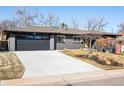 Well-maintained one-story home with a two-car garage and a concrete driveway and mature landscaping at 621 S Harrison Ln, Denver, CO 80209