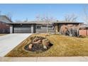 Charming single story home features a manicured front yard, attached garage, and a modern exterior at 621 S Harrison Ln, Denver, CO 80209
