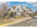 Multi-level condominium complex featuring balconies, exterior staircases, and professionally maintained landscaping at 1820 Newland Ct # 313, Lakewood, CO 80214