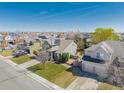 Wide aerial view of a neighborhood showcasing the home's placement among other residences and streets at 3788 Chavez St, Brighton, CO 80601