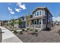 Charming home featuring professionally landscaped yard and inviting front porch seating at 8049 Monte Vista Cir, Littleton, CO 80125