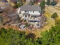 Aerial view of backyard deck with outdoor furniture, hot tub, and mature trees at 2174 Meadow Vale Rd, Longmont, CO 80504