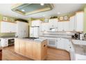 Bright kitchen features custom island, updated appliances, and hardwood floors at 2174 Meadow Vale Rd, Longmont, CO 80504