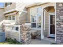 Charming entryway features a covered porch with stone accents, offering a warm welcome to visitors at 6237 Trailhead Rd, Highlands Ranch, CO 80130