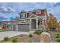Beautiful two-story home with stone details, three-car garage, and appealing front yard landscaping at 21900 E 46Th Pl, Aurora, CO 80019