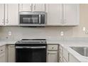 Modern kitchen appliances featuring a GE microwave and black oven range at 7767 Elmwood St, Littleton, CO 80125