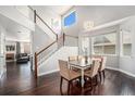 Bright dining room with beautiful hardwood floors, large windows, and elegant chandelier at 10647 Nucla St, Commerce City, CO 80022